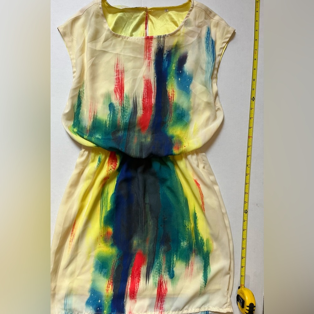 Colorful yellow dress with blues, green and mixed colors.